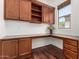 Office featuring built-in cabinets, desk space, hardwood floors, and a window with natural light at 30135 N 129Th Gln, Peoria, AZ 85383