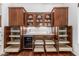 Spacious pantry features custom cabinets, pull-out drawers, and a built-in wine refrigerator at 30135 N 129Th Gln, Peoria, AZ 85383