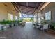 Inviting covered patio with comfortable seating, art, and outdoor dining, perfect for relaxing or entertaining guests at 30135 N 129Th Gln, Peoria, AZ 85383
