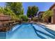 Inviting swimming pool features clean water, elegant stonework, and surrounding landscaping at 30135 N 129Th Gln, Peoria, AZ 85383