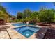 The pool and spa are surrounded by attractive hardscape and lush tropical landscaping at 30135 N 129Th Gln, Peoria, AZ 85383
