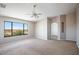 Bright bedroom with vaulted ceiling, plush carpeting and a large window overlooking desert views at 30375 W Verde Ln, Buckeye, AZ 85396