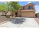 Charming home showcasing a manicured lawn, a two-car garage, and beautiful desert landscaping at 30375 W Verde Ln, Buckeye, AZ 85396
