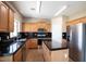 Well-equipped kitchen with stainless steel appliances, dark countertops, and stylish cabinetry at 30375 W Verde Ln, Buckeye, AZ 85396