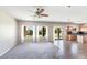 Open-concept living room with carpet and tile flooring, seamlessly connecting to the kitchen at 30375 W Verde Ln, Buckeye, AZ 85396