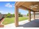 Covered patio overlooking a well-maintained backyard, perfect for outdoor relaxation and entertainment at 30375 W Verde Ln, Buckeye, AZ 85396
