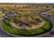 Beautifully landscaped roundabout at the community entrance with desert plants and palm trees at 30375 W Verde Ln, Buckeye, AZ 85396