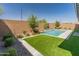 Landscaped backyard featuring a swimming pool and privacy fence with greenery at 3260 W Caleb Rd, Phoenix, AZ 85083
