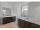 Bathroom featuring double sinks, sleek dark cabinetry and modern fixtures at 3260 W Caleb Rd, Phoenix, AZ 85083