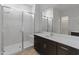 Bathroom featuring a glass shower, quartz countertop, modern fixtures and large mirror at 3260 W Caleb Rd, Phoenix, AZ 85083