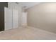 Bright bedroom with neutral walls, carpet flooring, closet with sliding doors, and entry to the ensuite bathroom at 3260 W Caleb Rd, Phoenix, AZ 85083