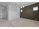 Bedroom with accent wall and modern light fixture at 3260 W Caleb Rd, Phoenix, AZ 85083