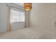 Bedroom features large window with light-filtering shades and stylish overhead light fixture at 3260 W Caleb Rd, Phoenix, AZ 85083