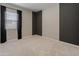 Bright bedroom featuring a stylish dark accent wall and plush carpet at 3260 W Caleb Rd, Phoenix, AZ 85083