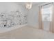 Stylish bedroom featuring unique wall art, a modern chandelier and lots of natural light at 3260 W Caleb Rd, Phoenix, AZ 85083