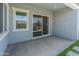 Covered patio featuring a sliding glass door and artificial turf and stone steps at 3260 W Caleb Rd, Phoenix, AZ 85083