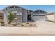 Charming single-Gathering home featuring a two-car garage, stone accents, and professionally landscaped front yard at 3260 W Caleb Rd, Phoenix, AZ 85083