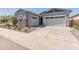 Home featuring a three car garage, desert landscaping and neutral colored stucco at 3260 W Caleb Rd, Phoenix, AZ 85083