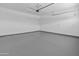 Spacious garage with epoxy flooring and a large insulated garage door at 3260 W Caleb Rd, Phoenix, AZ 85083