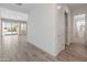 Hallway with wood-look tile, white walls, and doors leading to bedrooms, bathrooms, and living areas at 3260 W Caleb Rd, Phoenix, AZ 85083