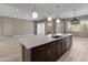 Kitchen island with stainless steel appliances, modern cabinets, and contemporary lighting at 3260 W Caleb Rd, Phoenix, AZ 85083