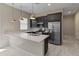 Modern kitchen featuring stainless steel appliances, a breakfast bar, modern pendant lights, and dark cabinetry at 3260 W Caleb Rd, Phoenix, AZ 85083