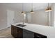 Modern kitchen featuring stainless steel appliances, a large sink, stone countertops, and dark cabinetry at 3260 W Caleb Rd, Phoenix, AZ 85083