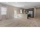 Open-concept kitchen and living area with stainless steel appliances, modern cabinetry, large windows, and breakfast bar seating at 3260 W Caleb Rd, Phoenix, AZ 85083
