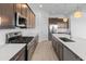 Beautiful kitchen with quartz countertops, stainless steel appliances and modern lighting at 3260 W Caleb Rd, Phoenix, AZ 85083