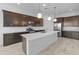 Modern kitchen with stainless steel appliances, dark wood cabinetry, and a large center island at 3260 W Caleb Rd, Phoenix, AZ 85083