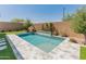 Backyard pool featuring travertine tile and artificial turf at 3260 W Caleb Rd, Phoenix, AZ 85083