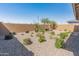 A xeriscaped backyard with desert landscaping and a brick fence at 3264 W Caleb Rd, Phoenix, AZ 85083