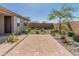 An exterior shot of the backyard with desert landscaping and a patio at 3264 W Caleb Rd, Phoenix, AZ 85083