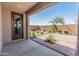 Inviting covered patio transitions into a landscaped backyard with mature trees and pavers at 3264 W Caleb Rd, Phoenix, AZ 85083