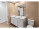 Bathroom featuring dual sinks, modern fixtures, and a toilet at 3264 W Caleb Rd, Phoenix, AZ 85083