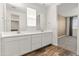 Bathroom featuring double vanity, wood-look flooring, and natural light at 3264 W Caleb Rd, Phoenix, AZ 85083