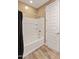 Bathroom with a tub-shower combo and a white door at 3264 W Caleb Rd, Phoenix, AZ 85083