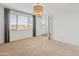 A bright and spacious bedroom with neutral carpet and a stylish light fixture at 3264 W Caleb Rd, Phoenix, AZ 85083