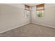 Neutral bedroom with plush carpet, natural window blinds and two tone paint at 3264 W Caleb Rd, Phoenix, AZ 85083