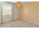 Cozy bedroom showcases neutral carpet, bright window and curtains, plus a honeycomb accent wall at 3264 W Caleb Rd, Phoenix, AZ 85083