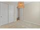 Neutral carpeted bedroom featuring a woven pendant light fixture and a closet with sliding doors at 3264 W Caleb Rd, Phoenix, AZ 85083