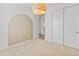 Inviting bedroom boasts neutral carpet and a pendant light fixture, with an arched doorway and closet at 3264 W Caleb Rd, Phoenix, AZ 85083