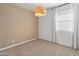 Bright bedroom featuring neutral carpet, ample natural light, and stylish woven pendant lighting at 3264 W Caleb Rd, Phoenix, AZ 85083