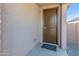 Inviting entryway with a dark brown door and a 'Welcome home' doormat at 3264 W Caleb Rd, Phoenix, AZ 85083