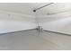 Clean two-car garage showcases a sealed floor and ample space for vehicles and storage at 3264 W Caleb Rd, Phoenix, AZ 85083