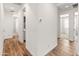 Bright hallway with wood-look tile floors offers views into other rooms in the home at 3264 W Caleb Rd, Phoenix, AZ 85083