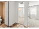 Hallway with views into a bathroom and bedroom, showcasing wood-look tile flooring at 3264 W Caleb Rd, Phoenix, AZ 85083