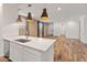 Kitchen island, stainless steel appliances, and views into living area at 3264 W Caleb Rd, Phoenix, AZ 85083