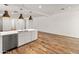 Bright kitchen island with stainless steel dishwasher and wood-look flooring at 3264 W Caleb Rd, Phoenix, AZ 85083