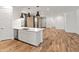 Open concept kitchen with island, stainless steel appliances and wood-look flooring at 3264 W Caleb Rd, Phoenix, AZ 85083